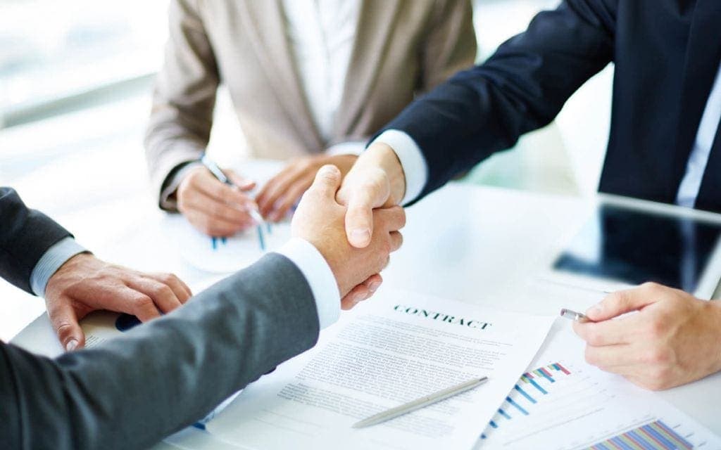 commercial-agreements-man-shaking-hand-in-meeting