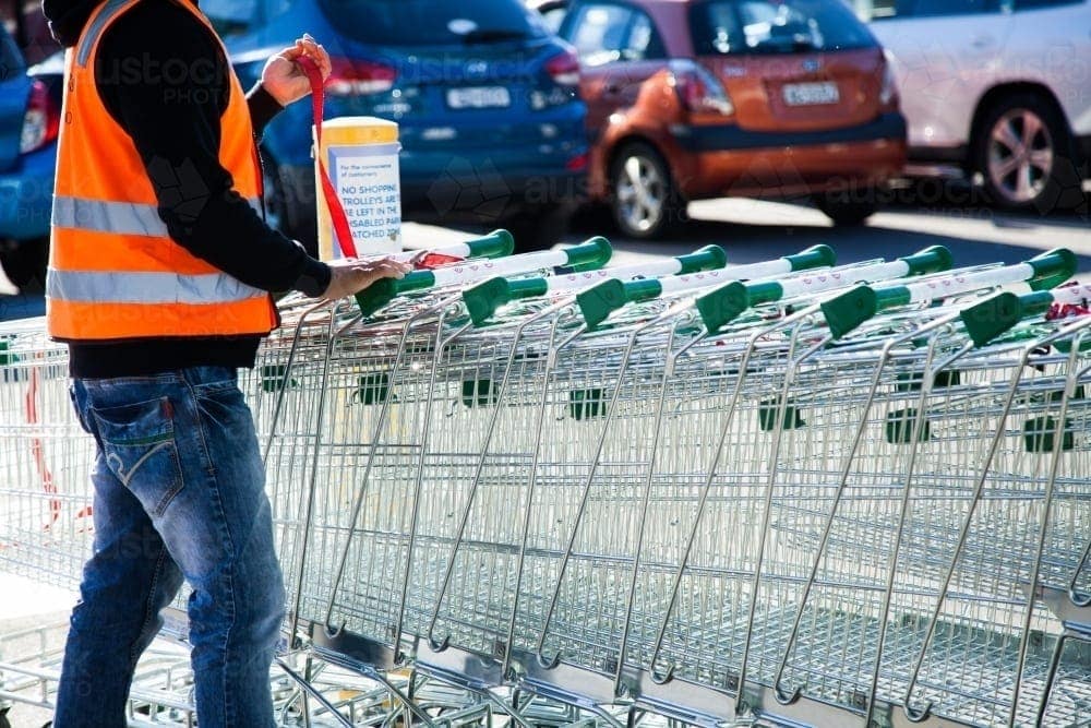 Consumer and Trade Disputes man collecting grocery trollies