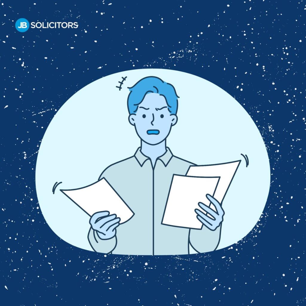 Person holding documents against blue background.