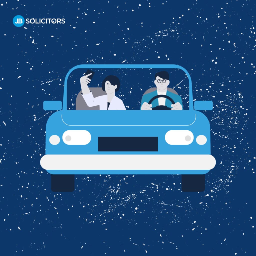 Two people in a blue car.